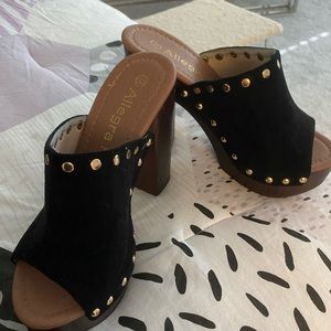 Sweet black suede slip-on sandals with gold stud detail and wooden heels